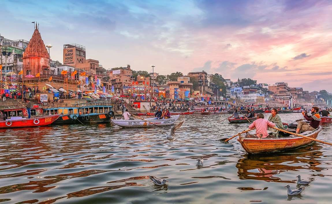 Varanasi, India, January 23,2019 Dashaswamedh Ganges river ghat Varanasi at twilight with tourists enjoying boating rides